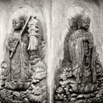 Black and white photograph by Bernard Donjean that shows two faces of the "Six-faced, six-body Jizo statue" located within the confines of the Adashino Nenbutsu-ji temple (name of the photograph : Side by Side Sculpted Jizos)