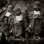 Black and white photograph by Bernard Donjean that shows three jizo statues carved in stone (name of the photograph : Jizo Carved in Stone)