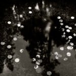 Black and white photograph by Bernard Donjean that shows some submerged coins (name of the photograph : Submerged Offerings)