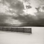 Black and white photograph by Bernard Donjean that shows a snow fence in winter (name of the photograph : Snow Fence, study 1)