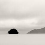 Black and white photograph by Bernard Donjean that shows the silhouette of a small island called Ao island (name of the photograph : Ao Island, #1)