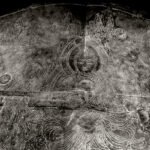 Black and white photograph by Bernard Donjean that shows an engraving of Buddha Shaka on a bronze lotus petal (name of the photograph : Engraved Shaka)