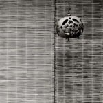 Black and white photograph by Bernard Donjean that shows an old japanese iron lantern suspended to a hook (name of the photograph : Hooked Lantern)