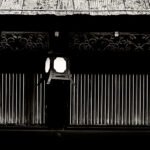 Black and white photograph by Bernard Donjean that shows a japanese lantern suspended to the roof of a temple (name of the photograph : Roof Lantern)