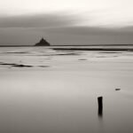 BayBlack and white photograph by Bernard Donjean that shows the Mont-Saint-Michel far away in the bay (name of the photograph : Mont-Saint-Michel Bay)