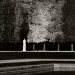 Black and white photograph by Bernard Donjean that shows a white statue face to to the "Bassin de Neptune" in the garden of Versailles Castle (name of the photograph : Bassin de Neptune's Statue)