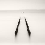 Black and white photograph by Bernard Donjean that shows a breakwater located in Nieuwesluis (name of the photograph : Breakwater Perspective)