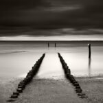 Black and white photograph by Bernard Donjean that shows the last breakwater of a naturist beach (name of the photograph : End of N. Beach)
