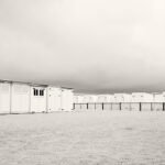 Black and white photograph by Bernard Donjean that shows some beach huts on the beach of Knokke (name of the photograph : Beach Huts)