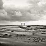 Black and white photograph by Bernard Donjean that shows a square-shaped structure on the beach of Knokke : The Square