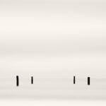 Black and white photograph by Bernard Donjean that shows four emerging posts (name of the photograph : Four Emerging Posts)