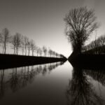 Black and white photograph by Bernard Donjean that shows a canal at dawn (name of the photograph : Canal at Dawn)