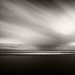 Black and white photograph by Bernard Donjean that shows a rain shower coming into the direction of the beach of Wenduine (name of the photograph : Approaching Rain)